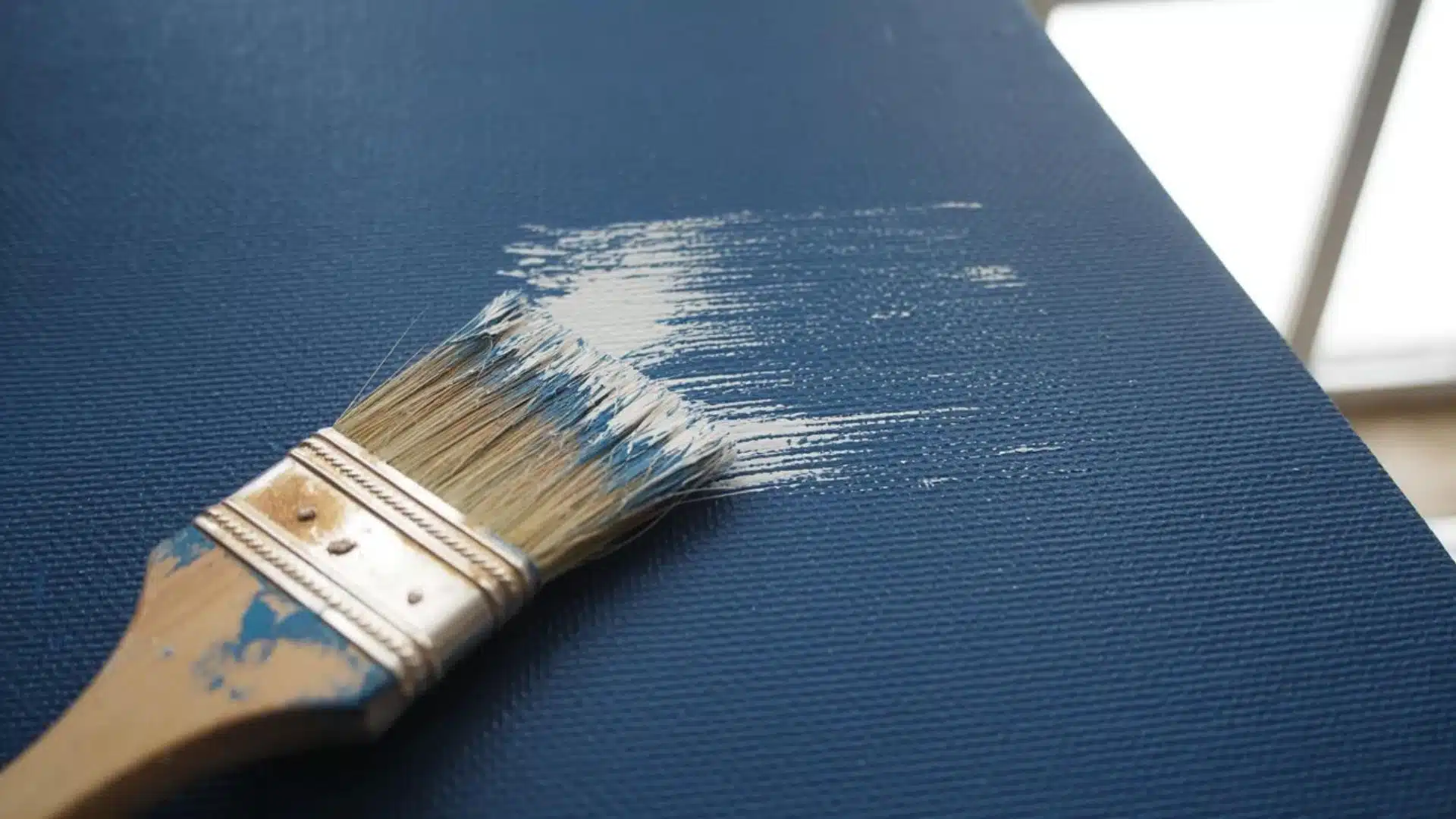 Dry-brushing technique with a brush on a painted surface.