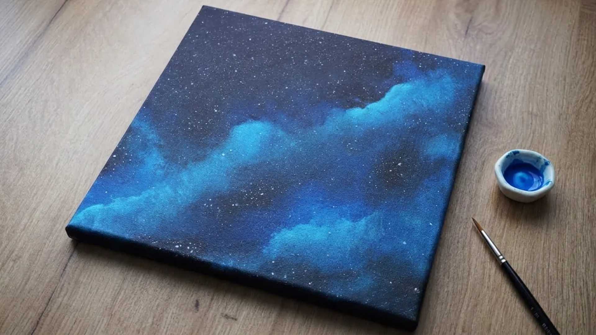 Beautiful galaxy painting with blue, black, and white stars