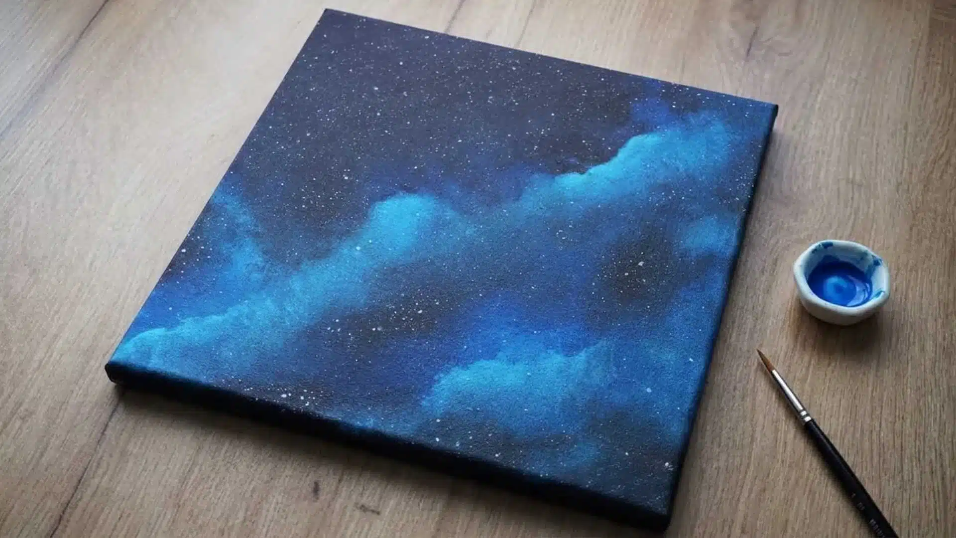 Beautiful galaxy painting with blue, black, and white stars