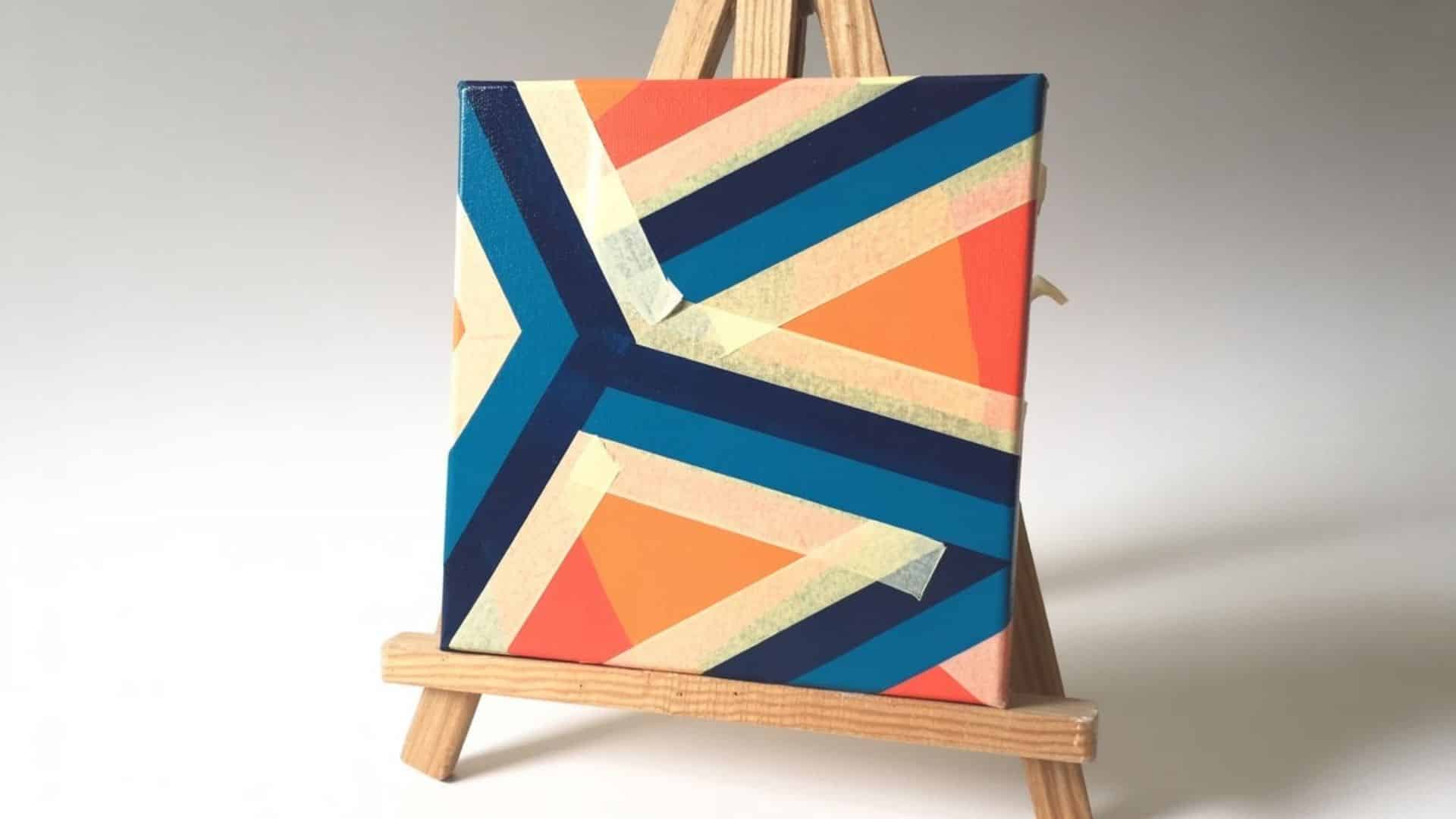  Geometric tape painting with bold blue, orange, and yellow colors