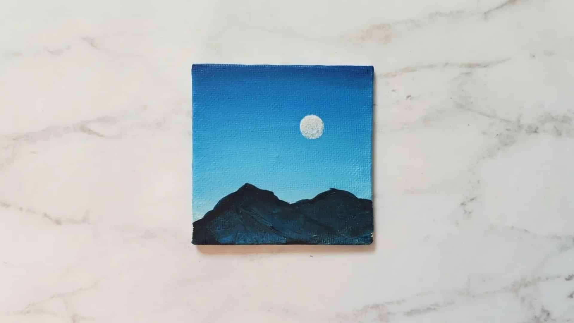 Silhouette of mountains with a full moon in the sky