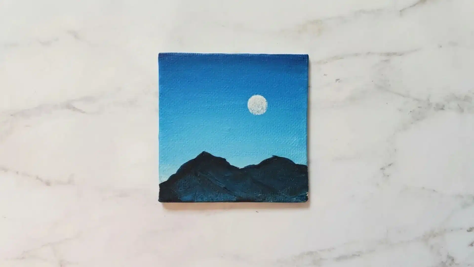 Silhouette of mountains with a full moon in the sky
